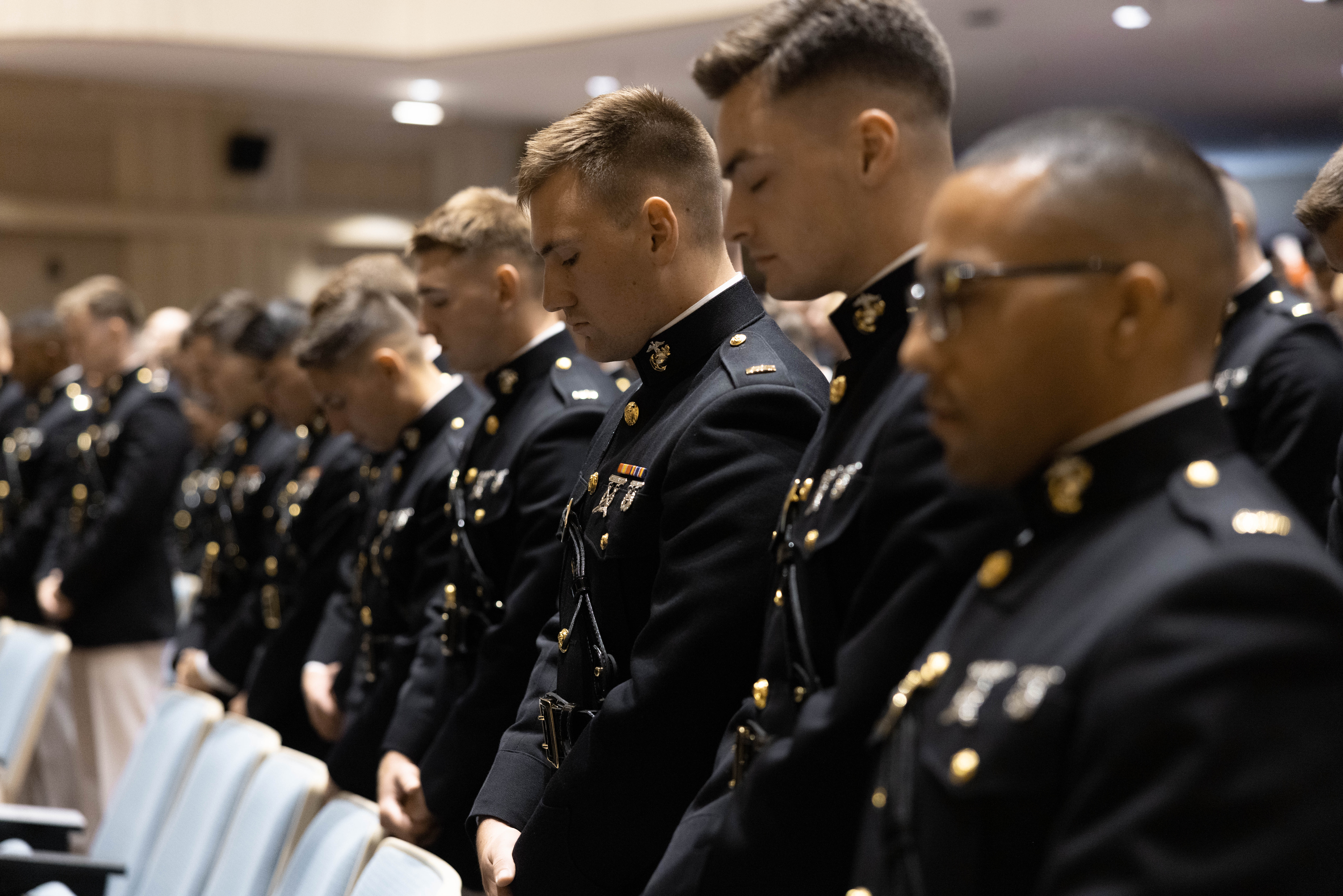 Marines with Bravo Company, Basic Officer Course 2-24, bow heads for final invocation during graduation at Little Hall on Marine Corps BaseQuantico, Virginia, June 28, 2024 (U.S. Marine Corps/Darien Wright)